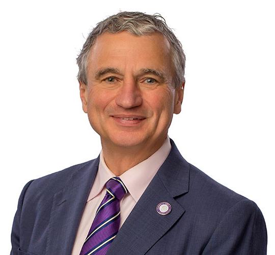 headshot of man with suit and tie