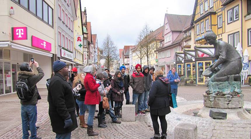 students being guided through a tour at a fountain