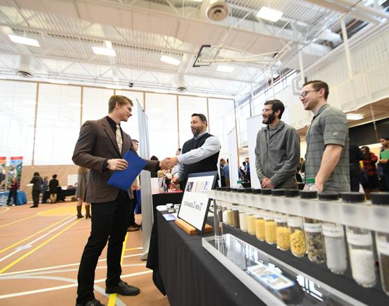 student meeting a group of employers at a job fair